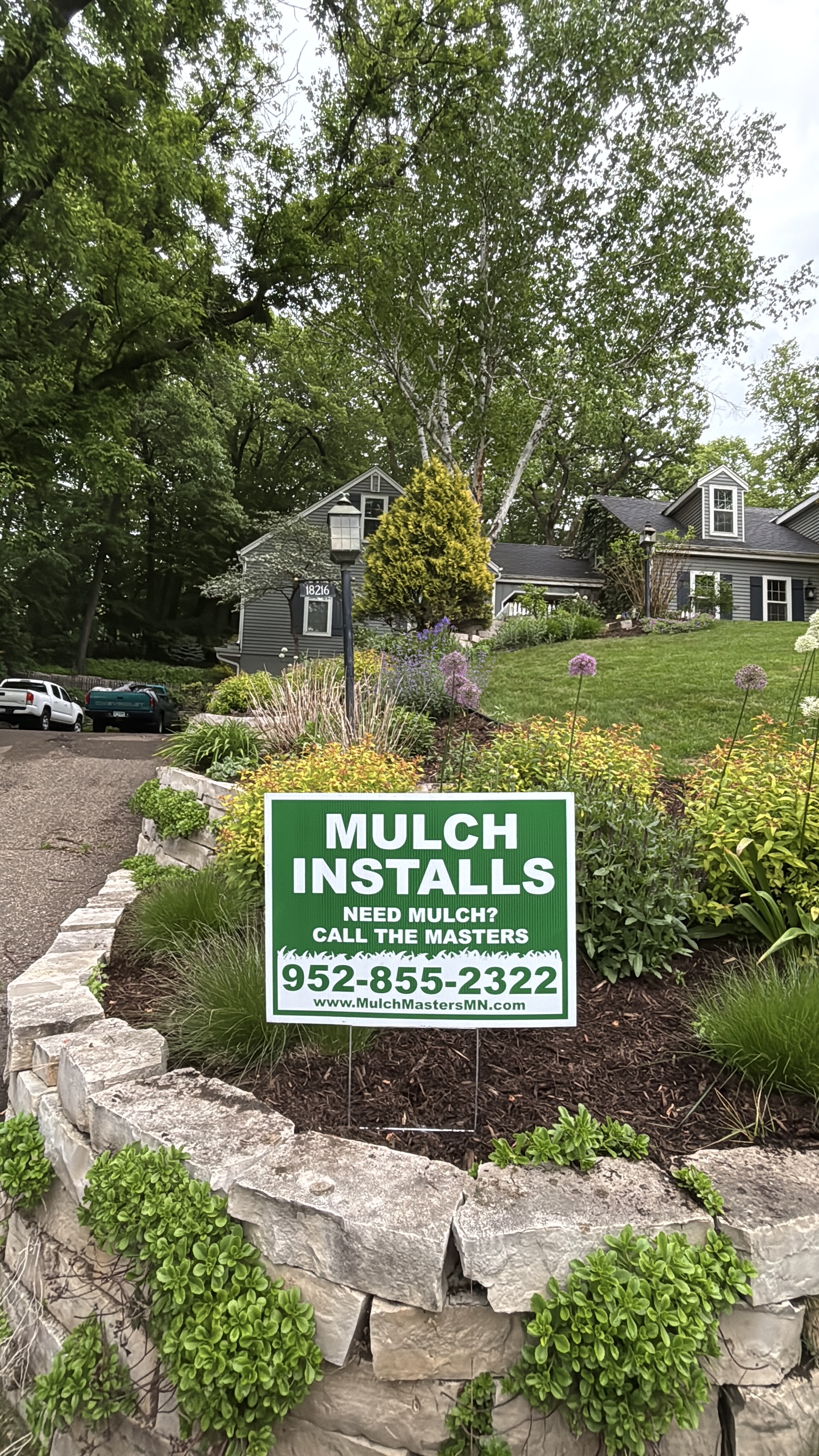 Beautiful landscaped yard with Mulch Masters sign