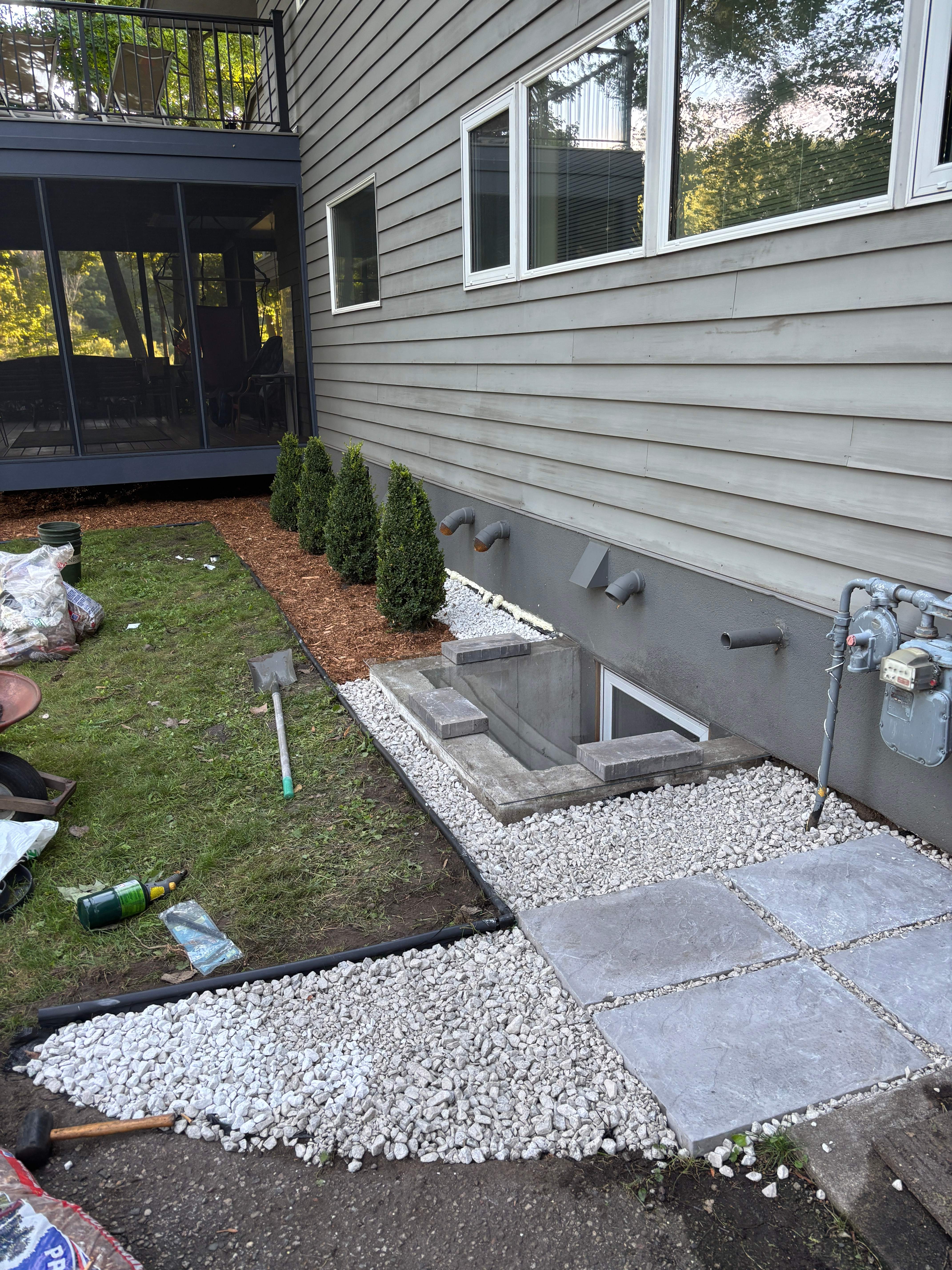 White rock hardscaping with stepping stones and shrubs